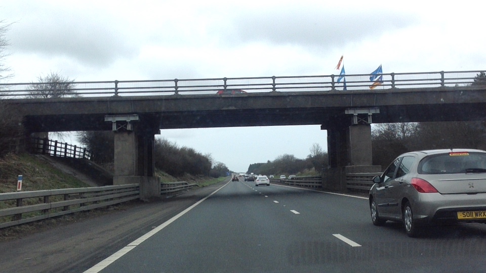#YesM8 flags across the motorway title=